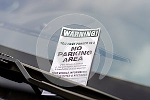 Close-up of parking ticket on car`s windshield