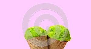 Close up part of green waffle cone on pink background. Copy space