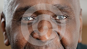 Close up part male face happy elderly African American man smiling with friendly dark black eyes. Handsome mature senior