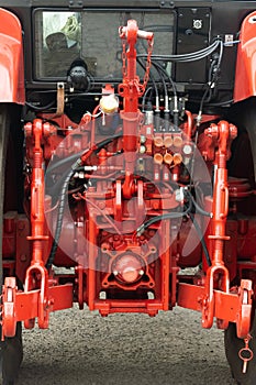 Close-up of part of the new red tractor. Vehicle assembly