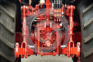 Close-up of part of the new red tractor. Vehicle assembly