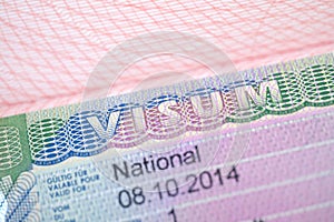 close-up part of page of document, foreign passport for travel with European visa, national visa stamp with shallow depth of field