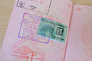 close up part of pages of foreign passport with foreign sri lanka visa, border stamps, permits to enter countries, concept of