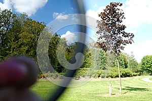 Close up of a part of a polarizer filter, show the difference with and without this filter, landscape background