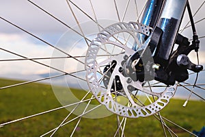 Close-up of part of a road bike brake disc. Details about the front axle disc brake damper of a bicycle. Part of a