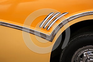 Close up of part of a yellow 1950`s classic car, in Havana, Cuba