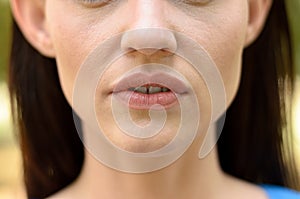 Close up on the parted lips of a thin woman photo