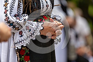 Close-up partial view of a woman wearing the handsewn traditional costume