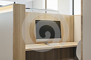 Close up of partitioned wooden workplace with empty computer screen and mock up place.