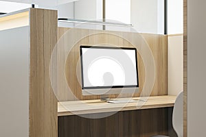 Close up of partitioned wooden workplace with empty white computer screen and mock up place.
