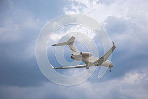 Close-up of a passenger plane flying against on the background of a stormy sky and clouds