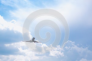 Close-up of a passenger plane flying against a blue sky