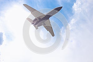 Close-up of a passenger plane flying against a blue sky