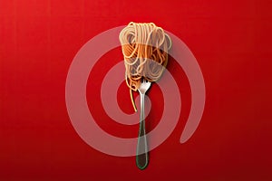 Close up of pasta isolated on red background in spoon or fork