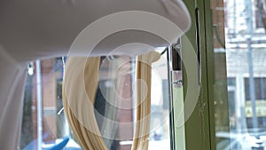 Close-up of a pastry chef stretching liquid caramel on a hook in a pastry shop.