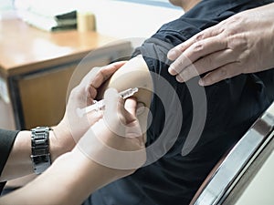 Close up of patient getting a vaccination in the hospital.