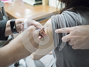 Close up of patient getting a vaccination in the hospital.