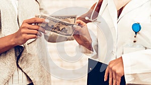 Close Up Patient Hands Giving Money to Doctor