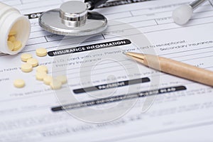 Close-up of patient information concept,Stetoscope and medicine,pen on patient form on the desk.