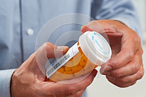 Close up of patient pouring out RX pills