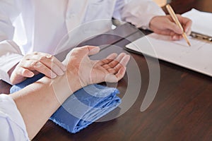 Close Up of Patient's Hand While Doctor Takes Pulse