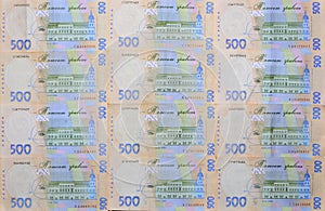 A close-up of a pattern of many Ukrainian currency banknotes with a par value of 500 hryvnia. Background image on business in Ukr
