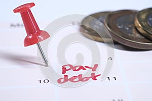 Close up of pay debt word on calendar