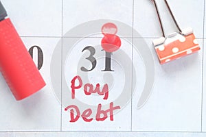 Close up of pay debt word on calendar