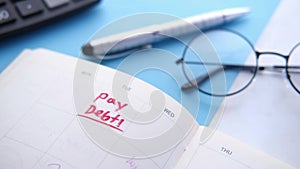 Close up of pay debt word on calendar