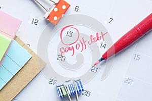 Close up of pay debt word on calendar