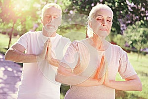 Close up of peaceful family meditating outdoors