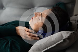 Close up peaceful woman in wireless headphones enjoying music