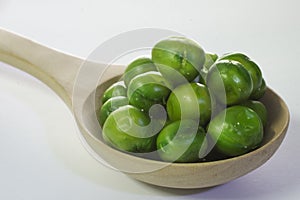 Close-up peas in wooden spoon