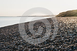 Close up of pebbles on a beach, as sunset