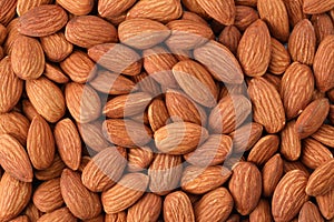 Close up peeled almonds nuts background top view using for your advertising