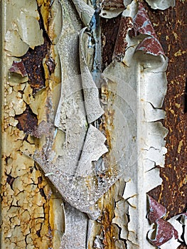 Close-up of peeling paint of dark painted wall