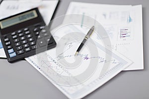 Close up.pen, financial chart and calculator on the businessman`