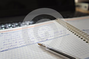 Close-up of a pen on a notepad or agenda