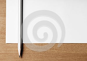 Close up of pencil and blank paper on a desktop