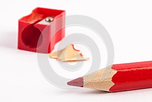 Close up Pencil sharpener and red wooden pencils on white backgroundpencils isolated on white background