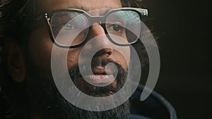 Close up pensive male face in eyeglasses looking to side. Bearded man thinking dreaming. Guy look distance think idea