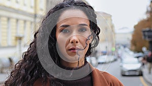 Close-up pensive serious sad millennial girl 30s woman brunette hispanic lady female with long curly hair and natural