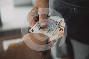 Close up of people exchanging cash banknote money. Concept of giving and taking euros. Economy and business. Present and loan back