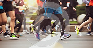 Close up of People`s Feet Running Marathon Race on City Road. Motion Blur.