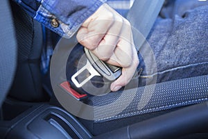 Close Up Of Person In Car Fastening Seat Belt