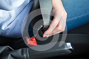 Close Up Of Person In Car Fastening Seat Belt