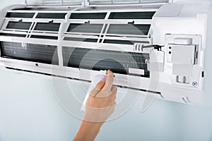 Close-up Of Person Cleaning Air Conditioner