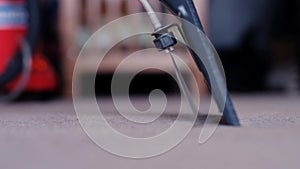 Close-up Of A Person Cleaning Carpet With Vacuum Cleaner