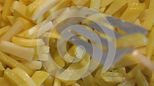 Close-up person frying french fries