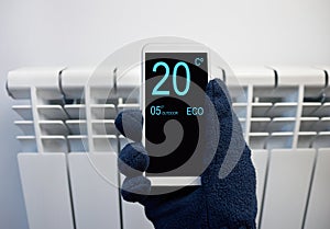 Adjusting temperature on thermostat with smartphone photo